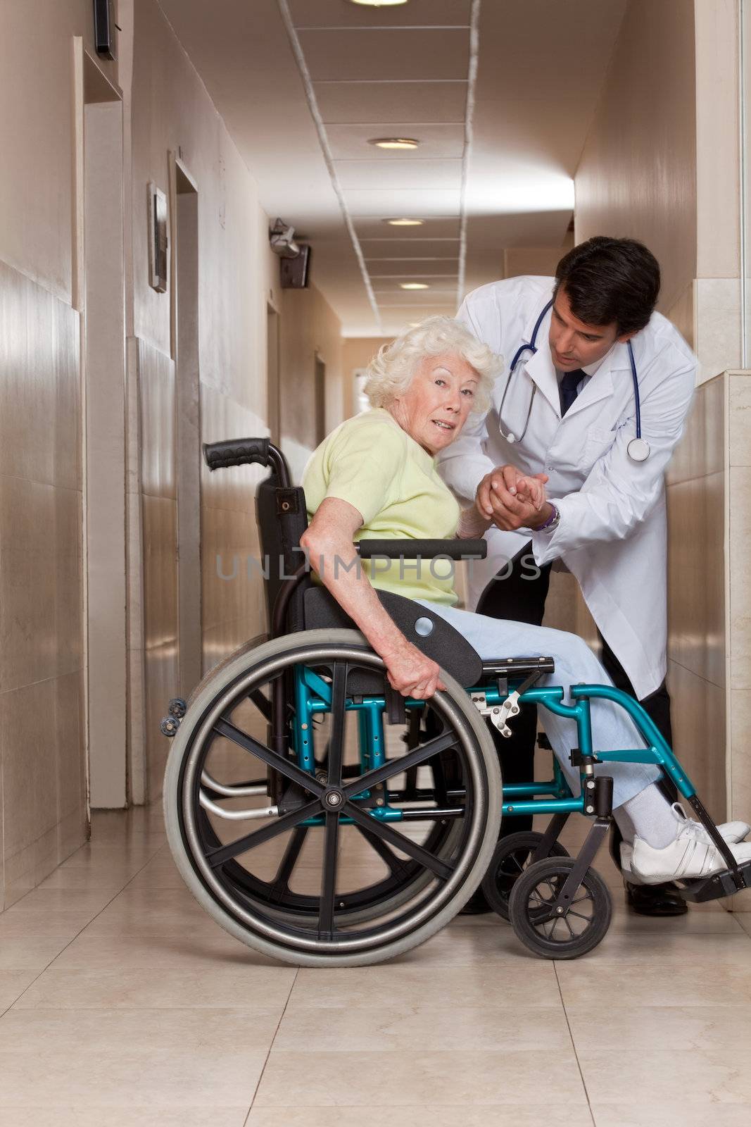 Doctor with Patient on Wheel Chair by leaf