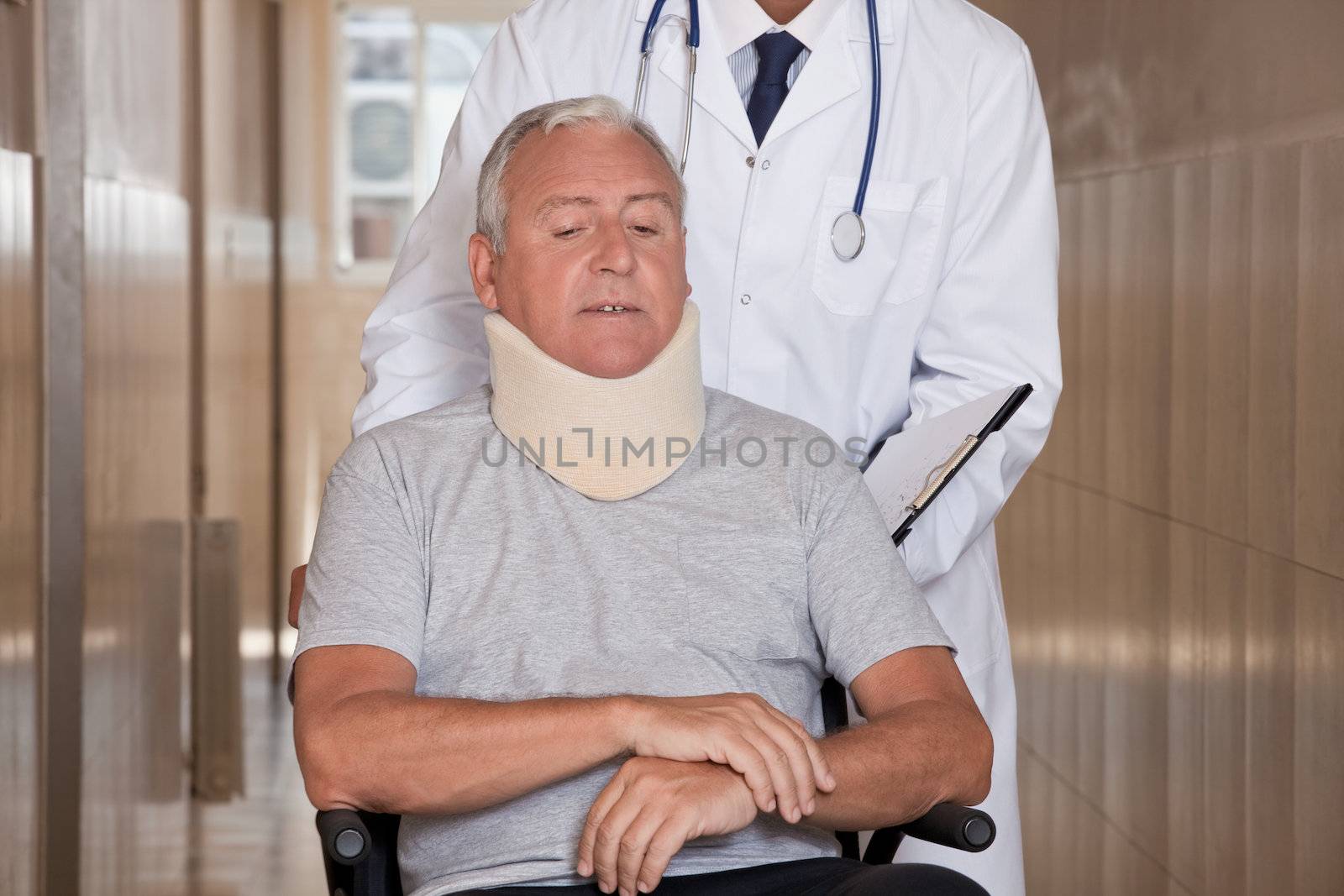 Doctor with Patient in Wheelchair by leaf