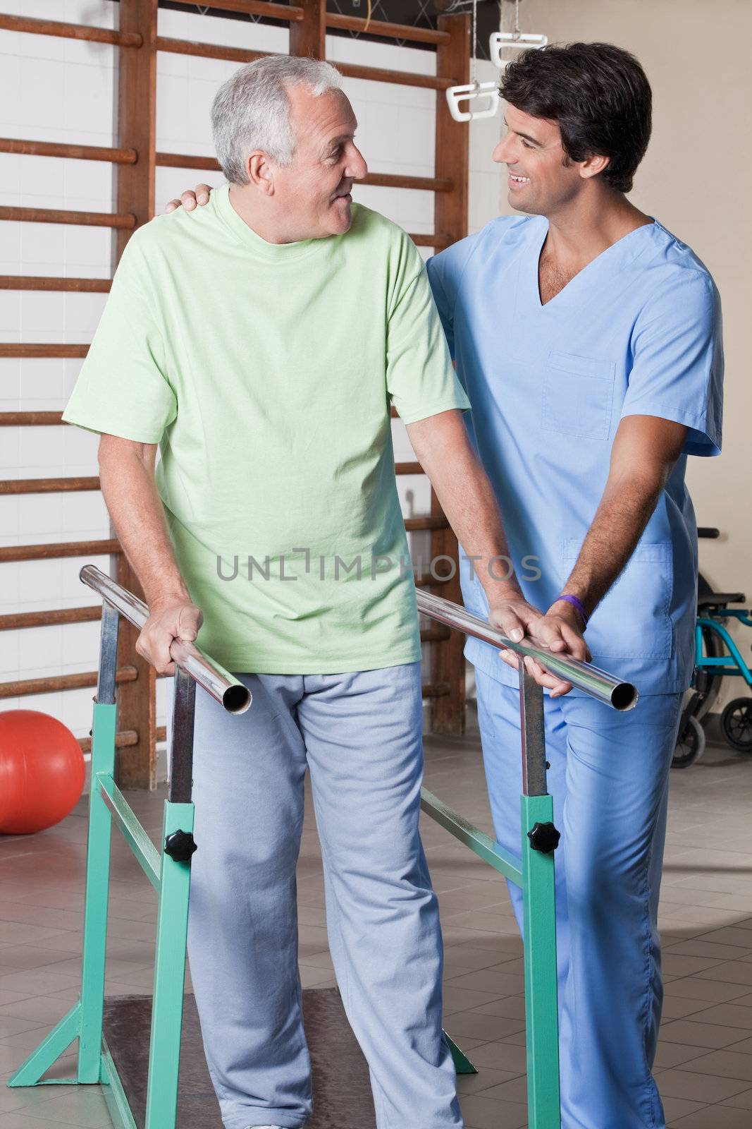 Senior man having ambulatory therapy with his therapist.