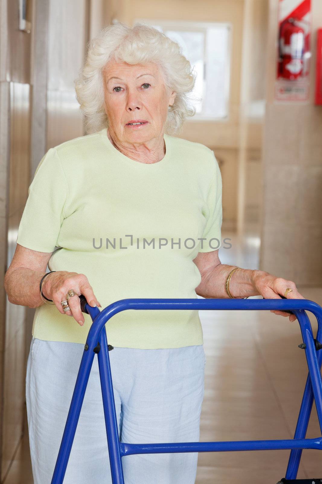 Portrait of a senior woman in hospital using Zimmer frame