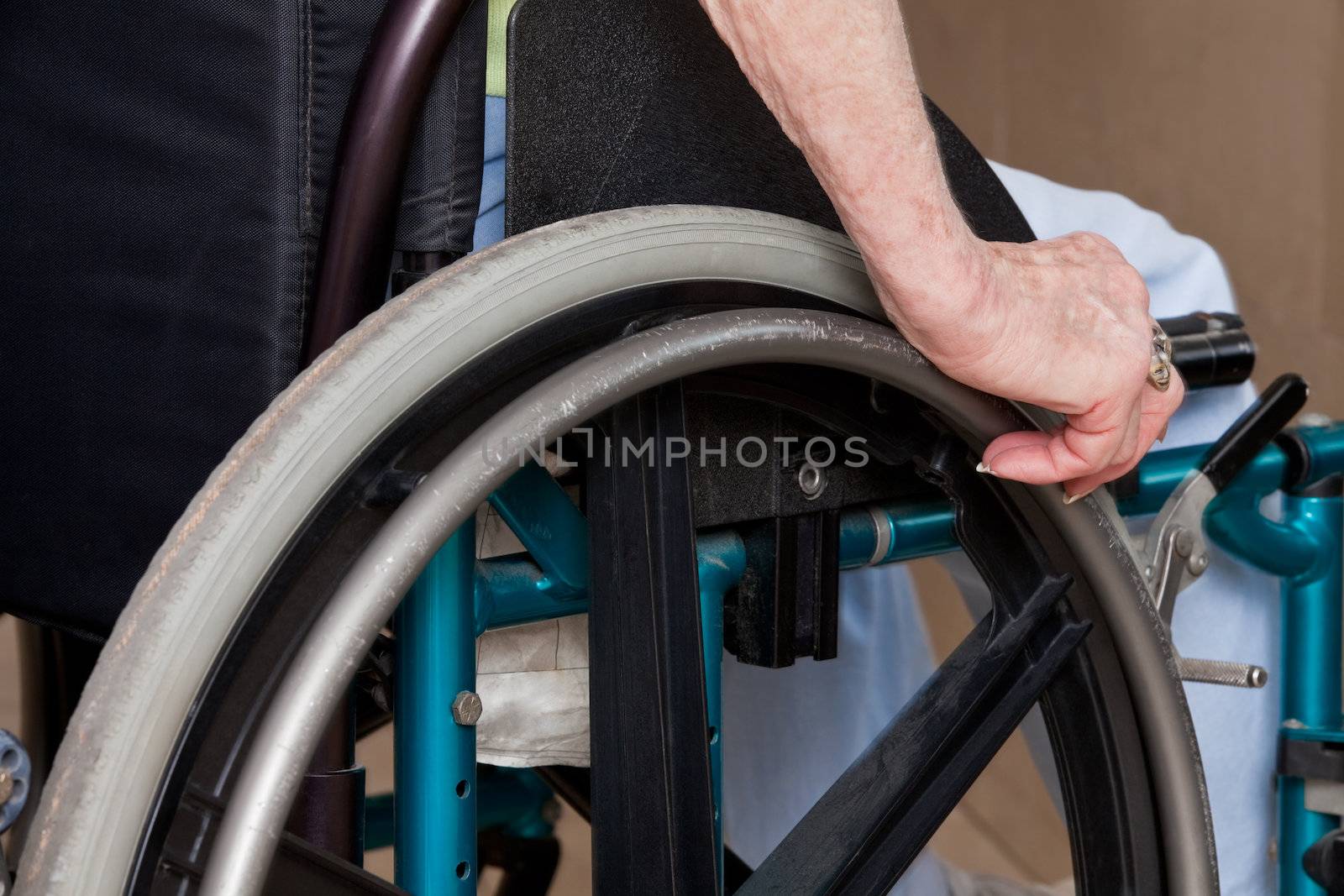 Woman's Hands on Wheelchair by leaf