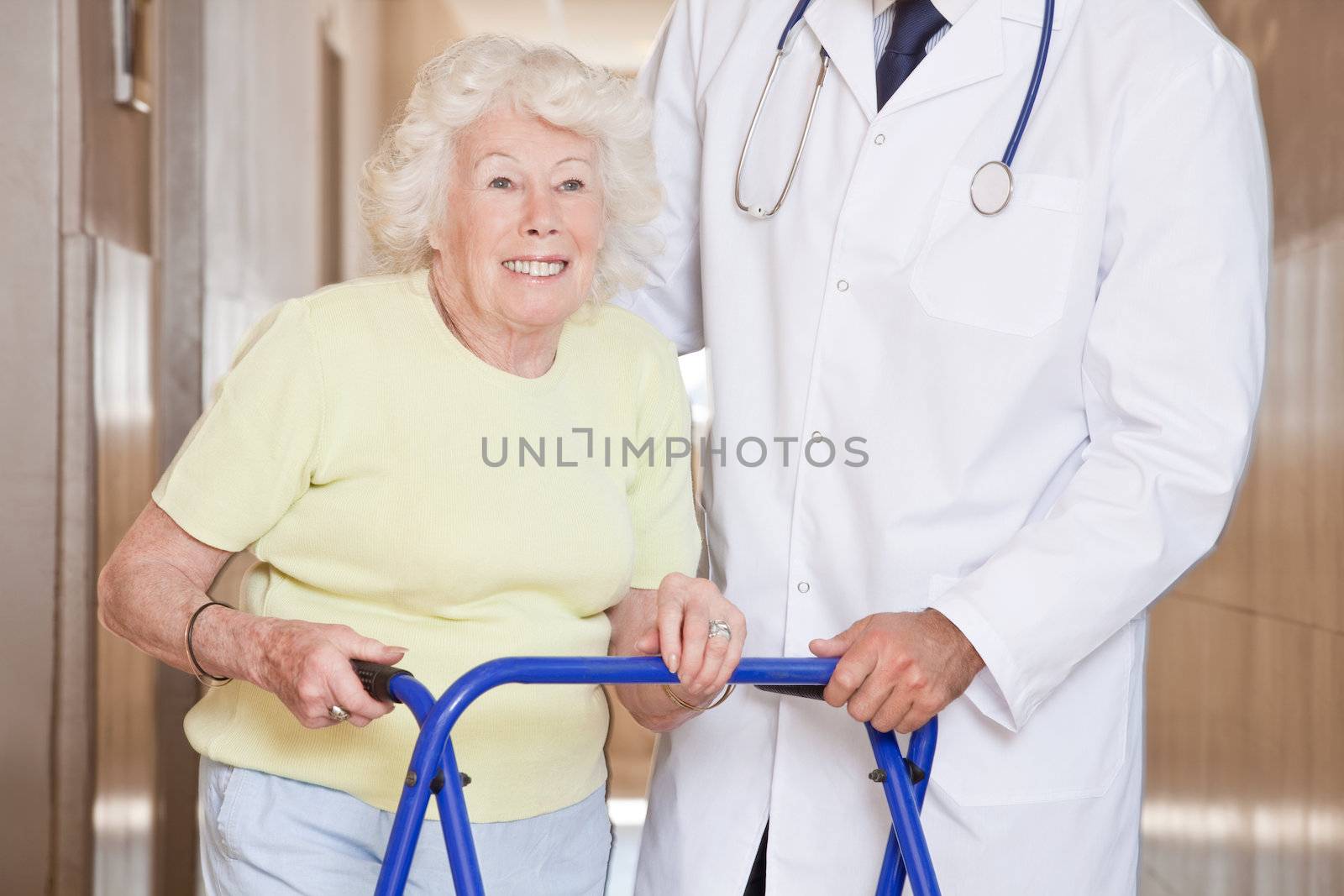 Portrait of elderly woman and doctor with zimmerframe.