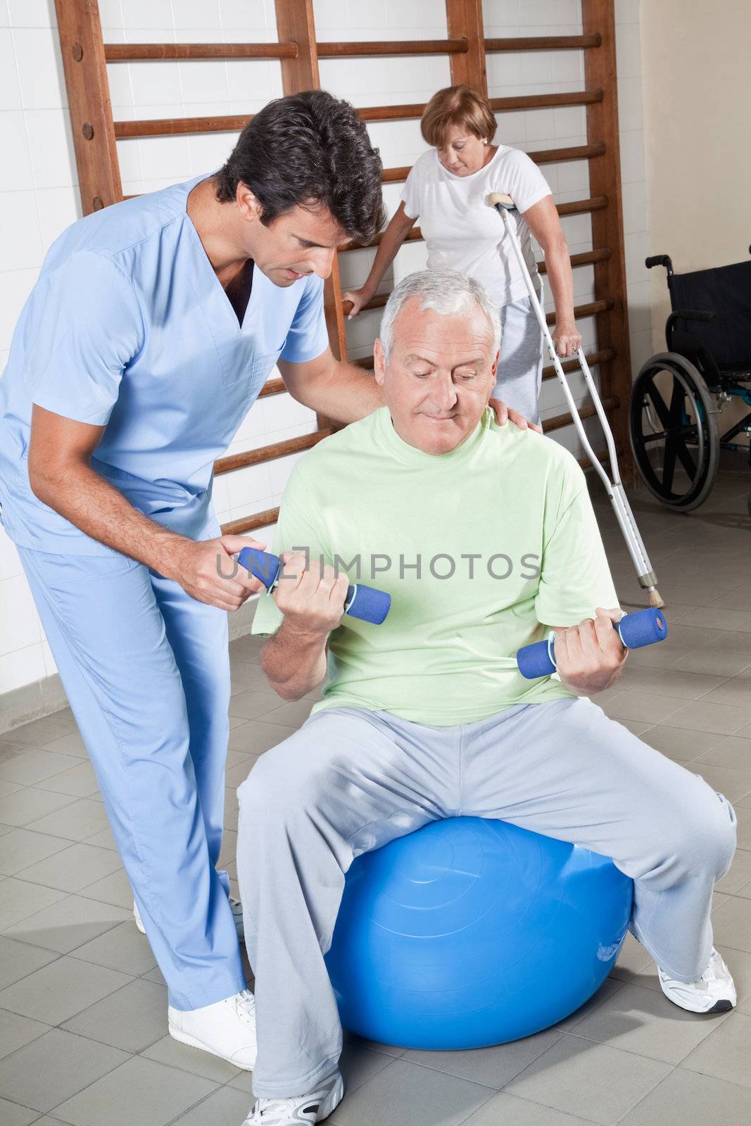 Male Physical therapist helping a patient.