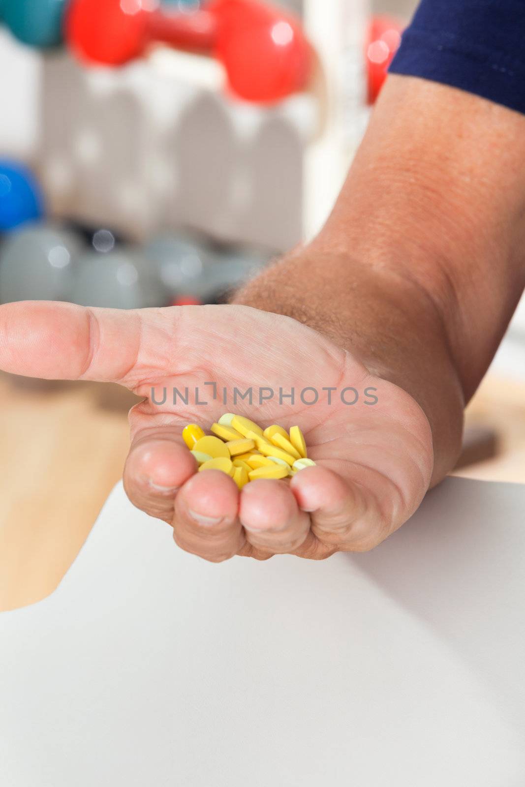 Close-up of senior man's hand holding tablets