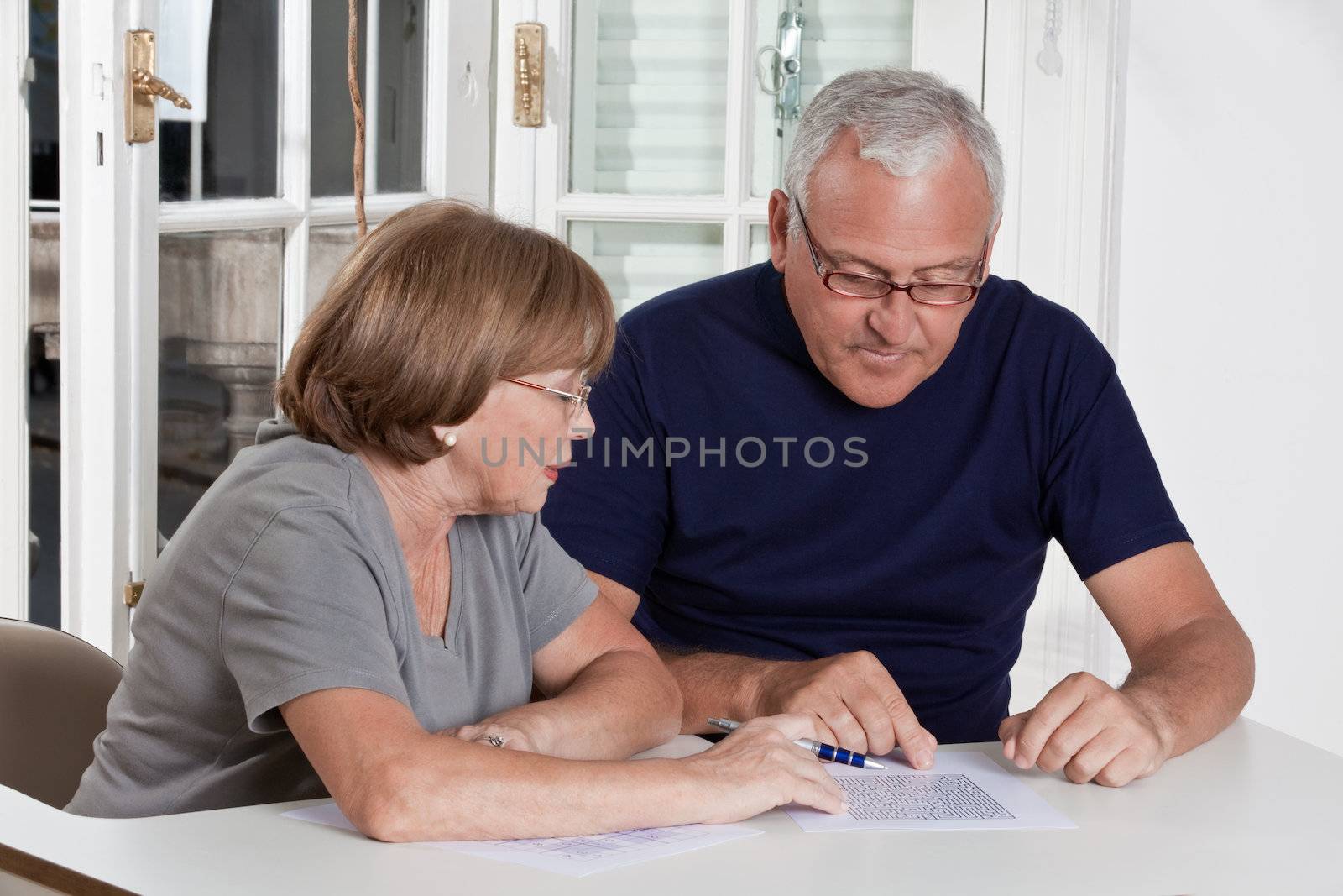 Mature Couple playing Scrabble Game by leaf