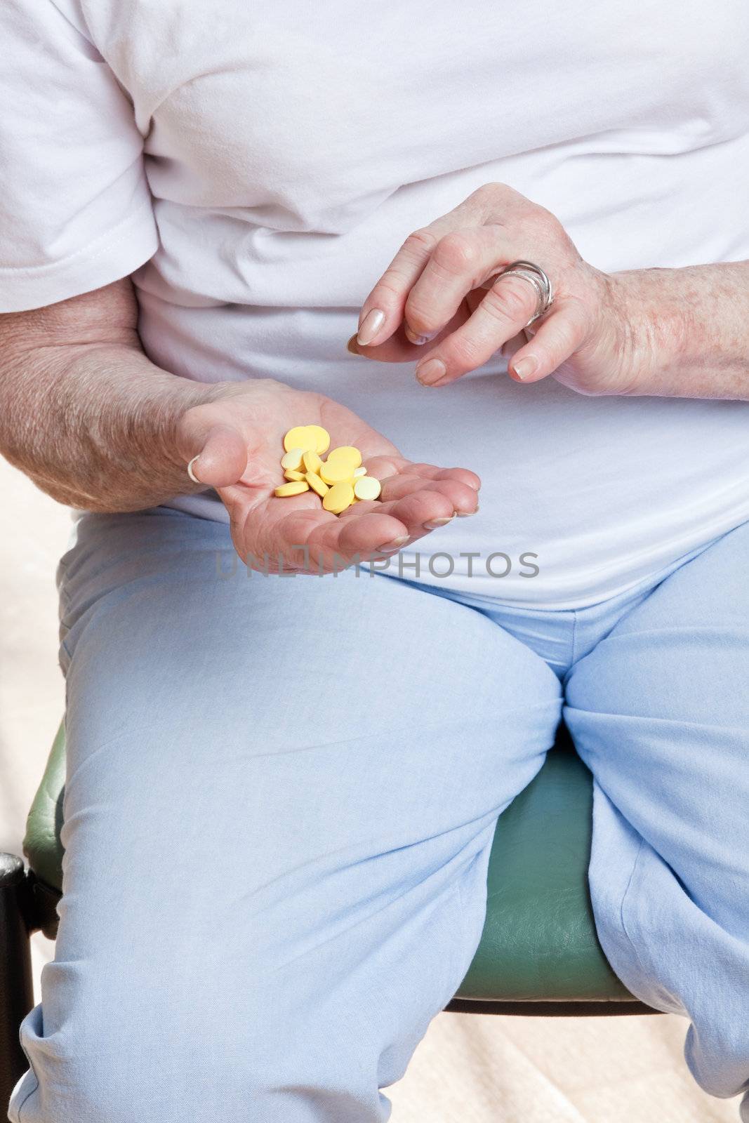 Sick senior woman holding her pills.