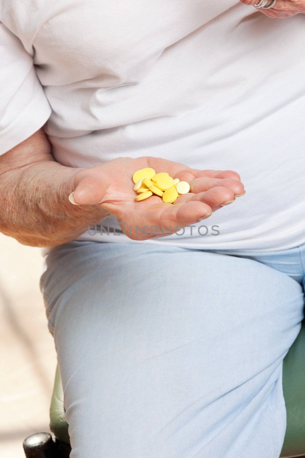 Senior Female Patient Holding Tablets by leaf