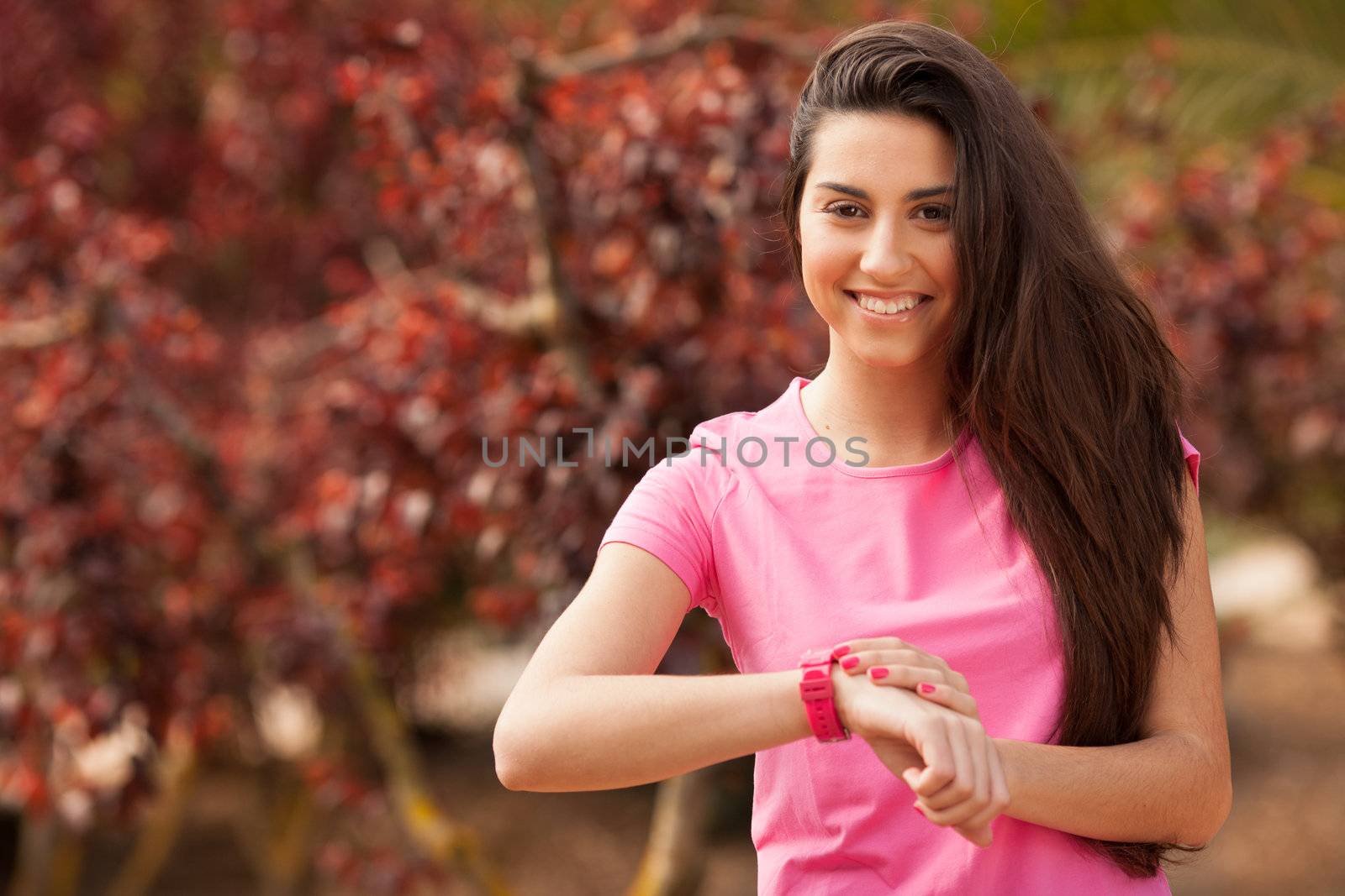 Sport woman checking heart rate in pink watch