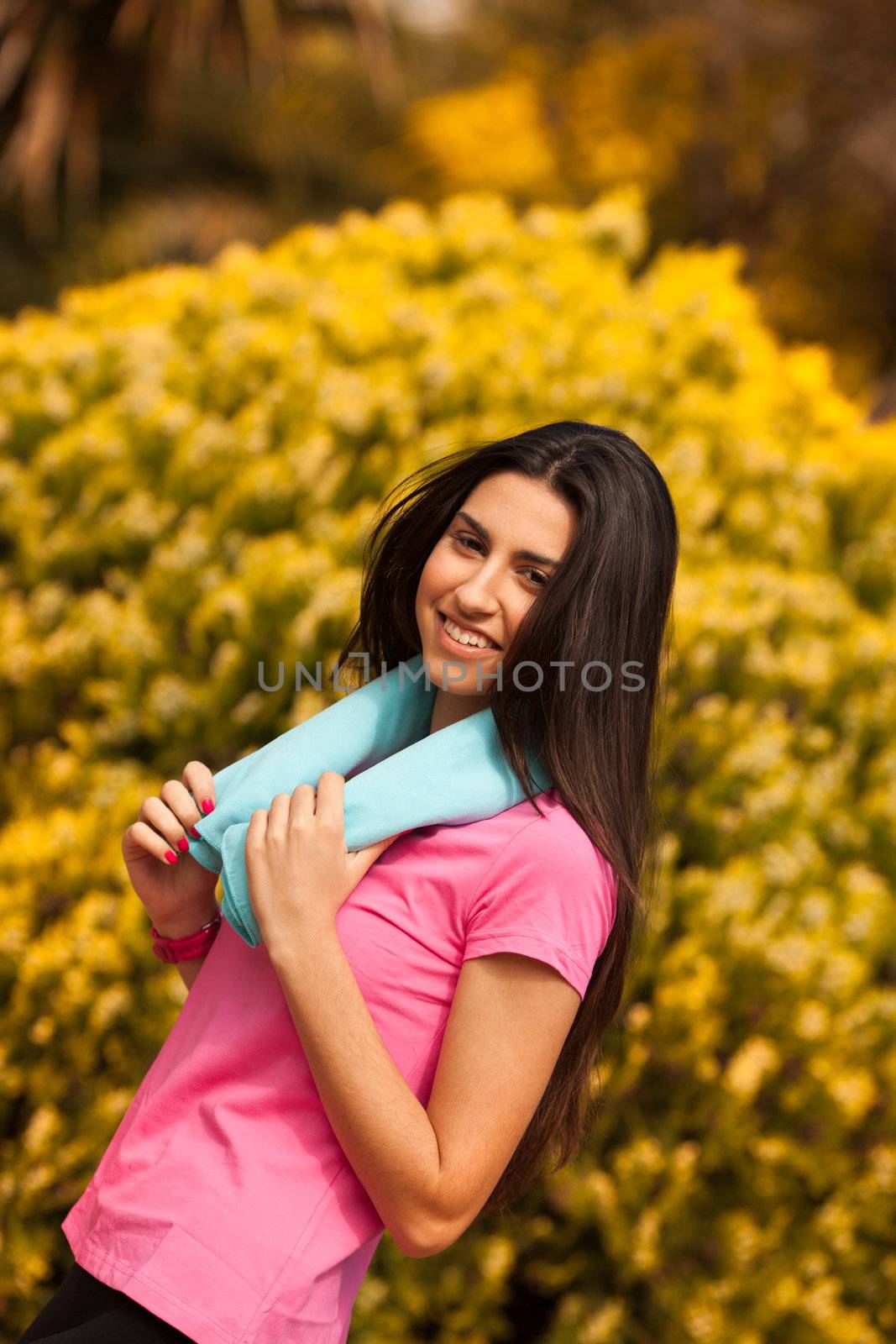 Sport woman with blue towell enjoying after fitness session