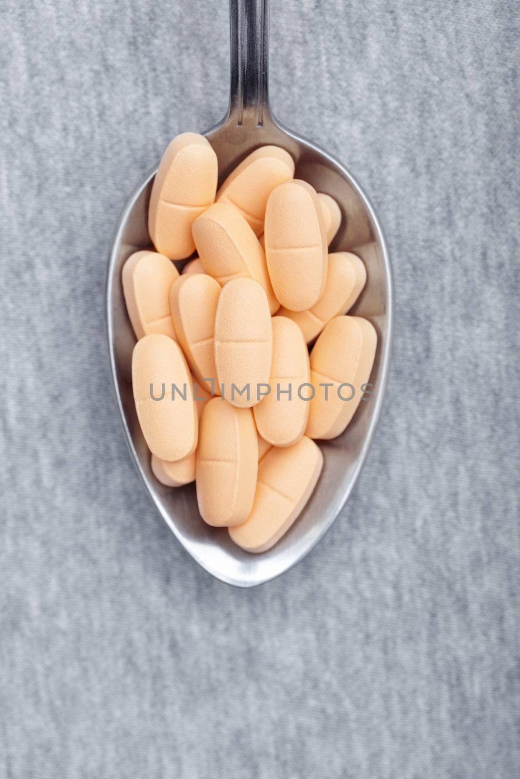 Pills on a metal spoon. Close-up photo
