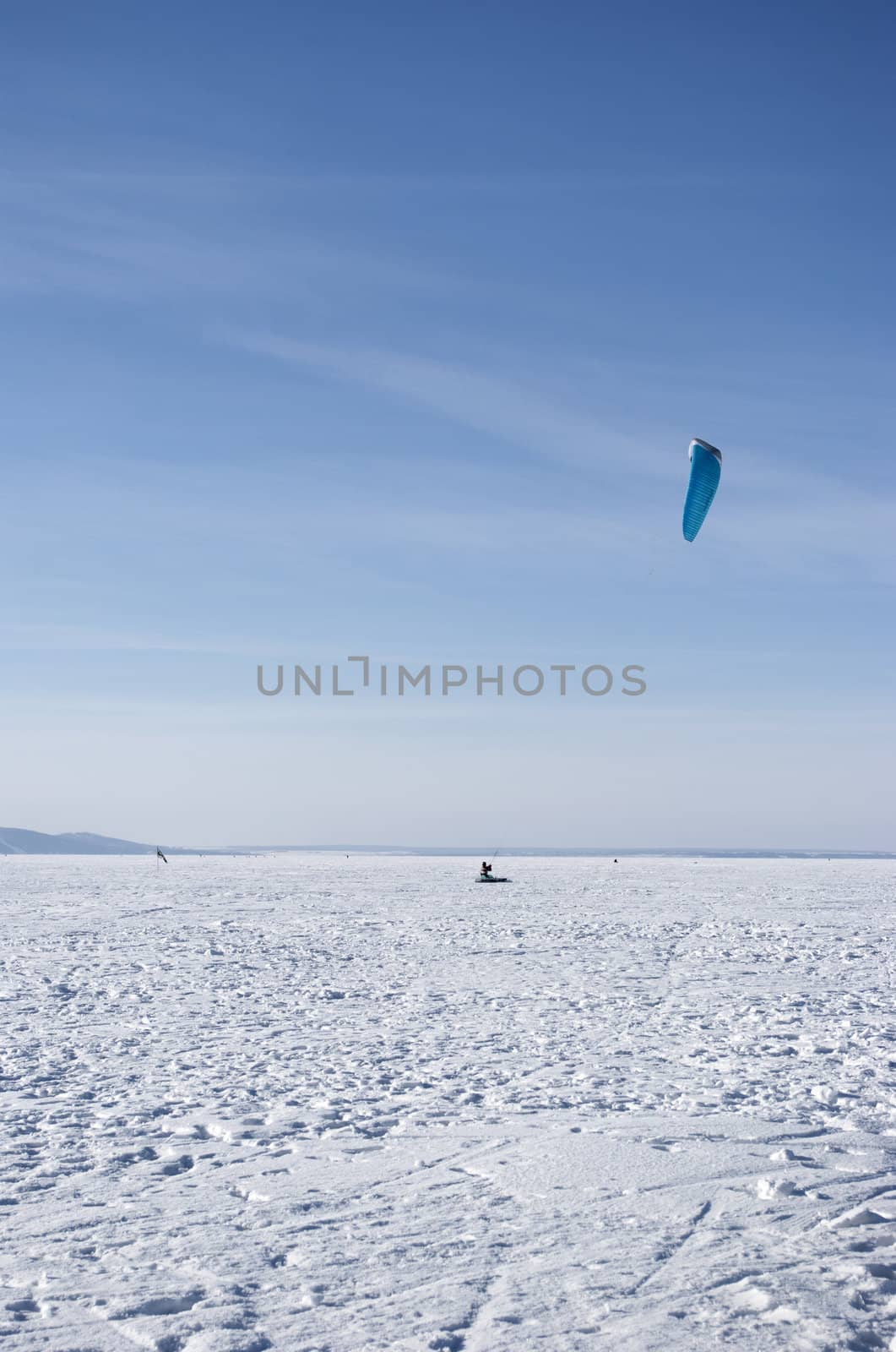 Winter kite skiing on the frozen river