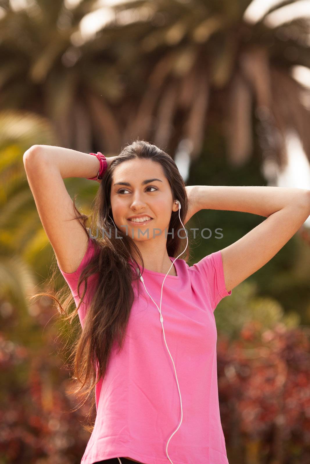 Young beautiful woman enjoying with headphones outdoors by Lcrespi