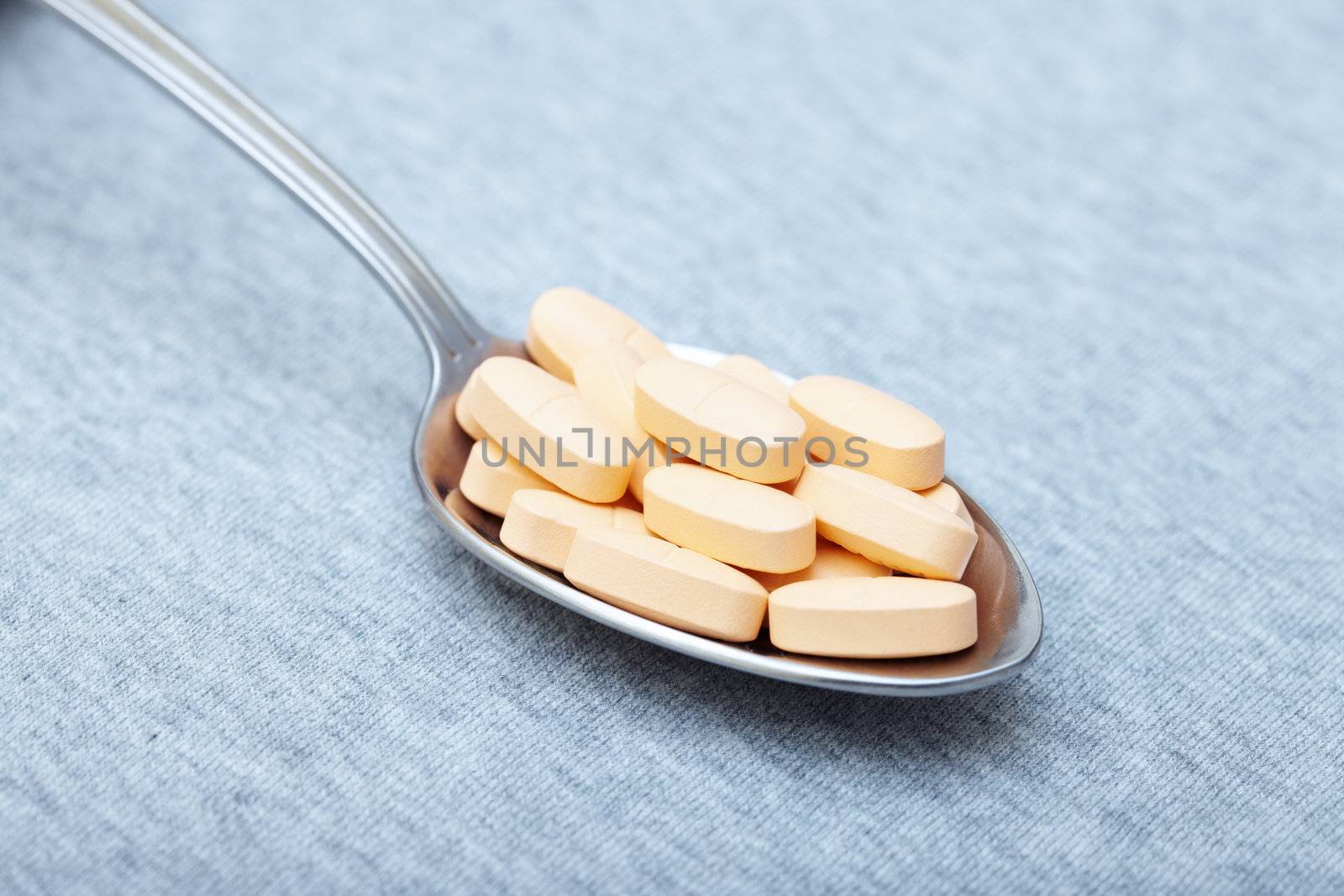 Pills on a metal spoon. Close-up photo