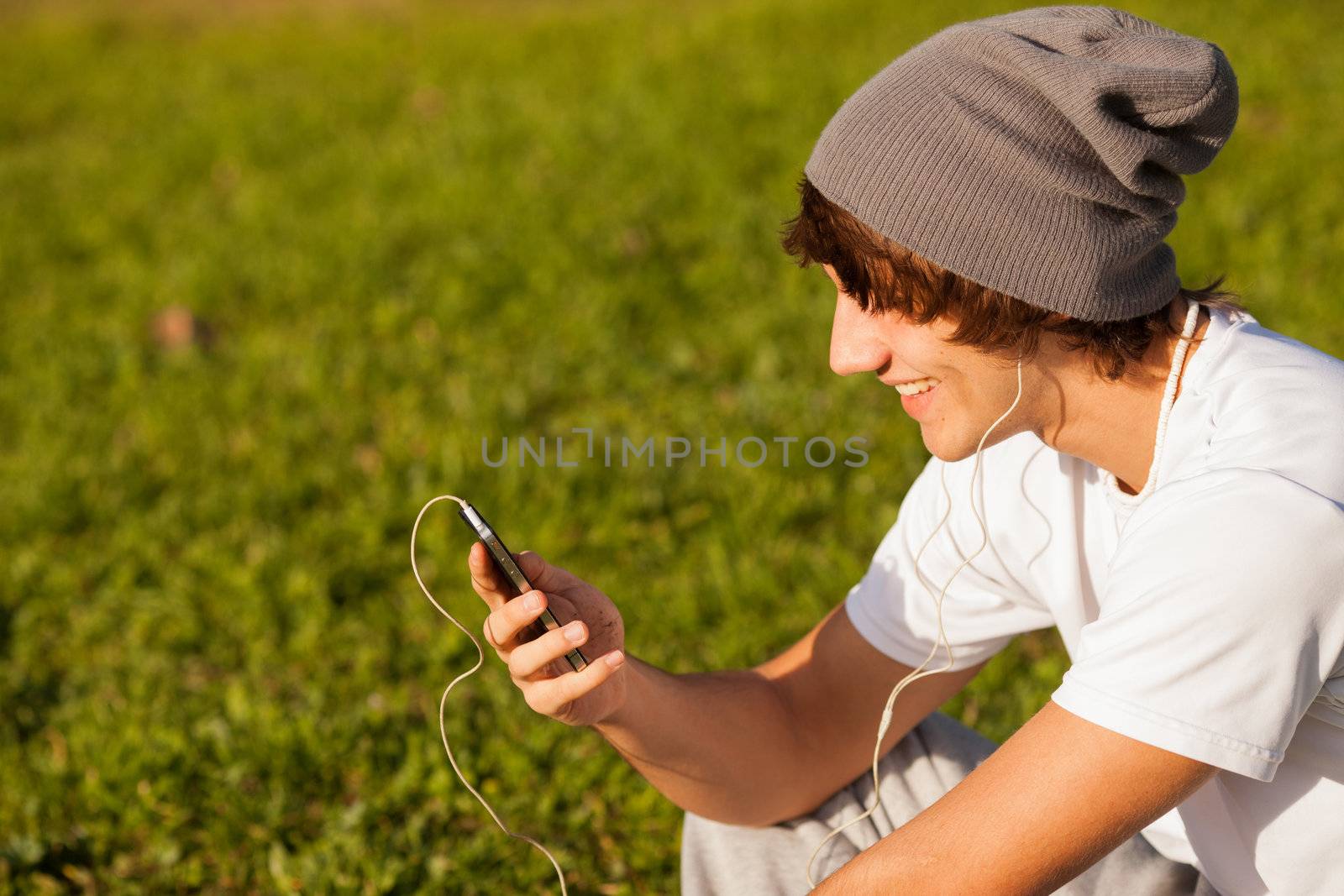 young handsome man consulting phone outdoors