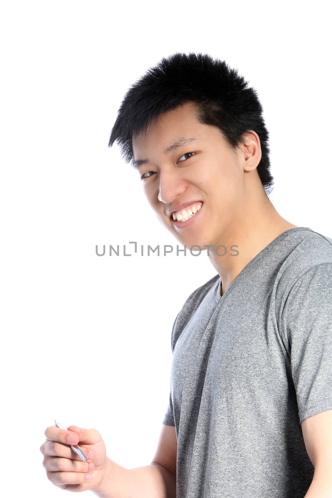 Casual young Asian man holding a pen and smiling isolated on white