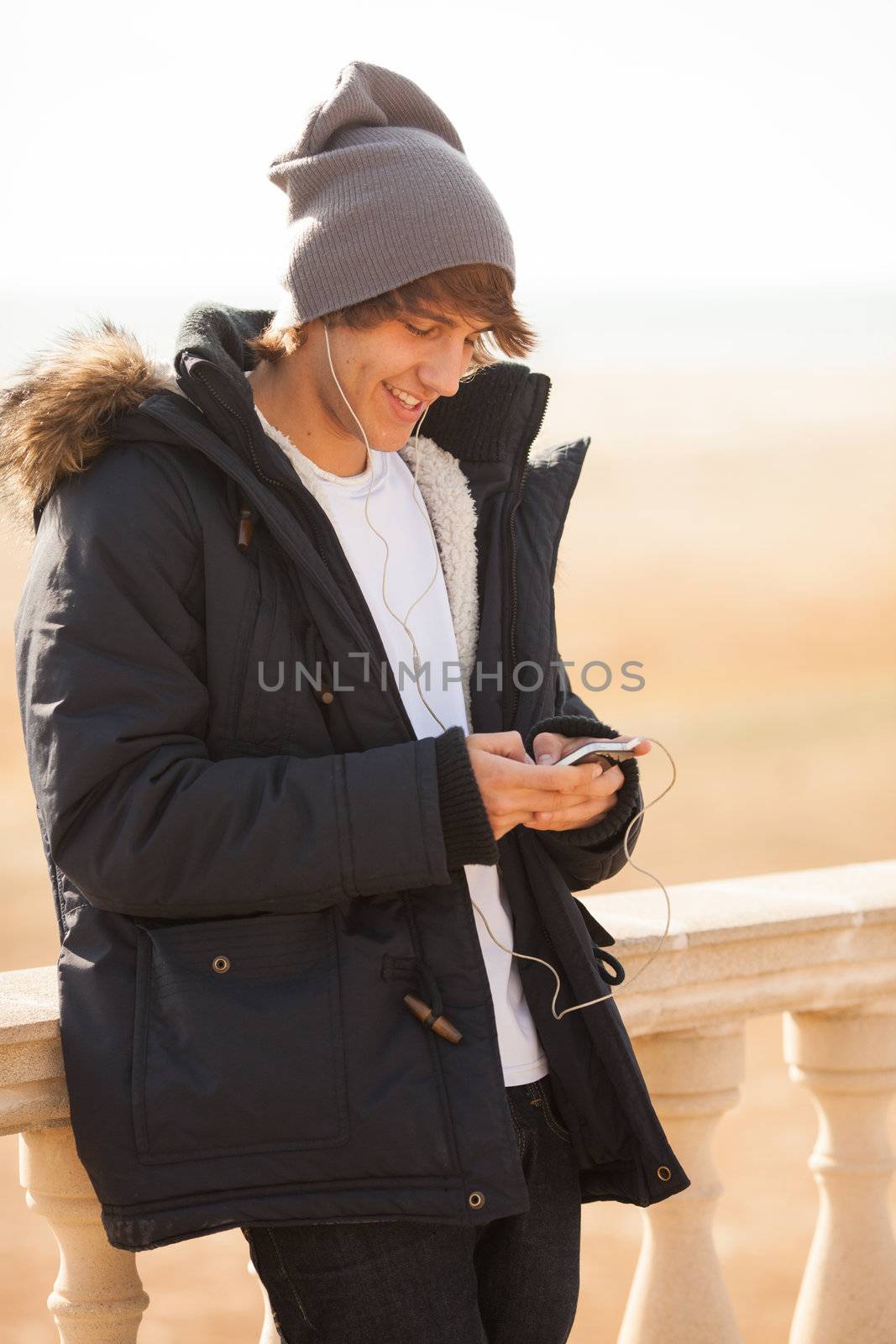 young handsome man consulting phone outdoors