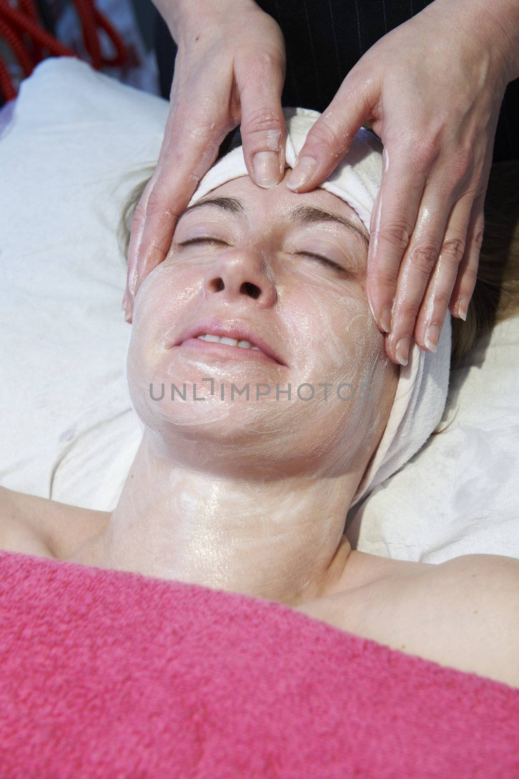 woman having a facial treatment in beauty salon