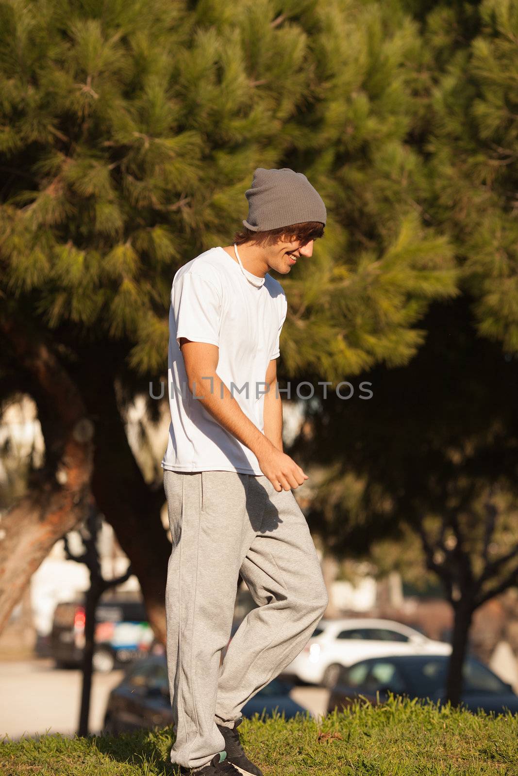 young handsome man jogging in public park by Lcrespi