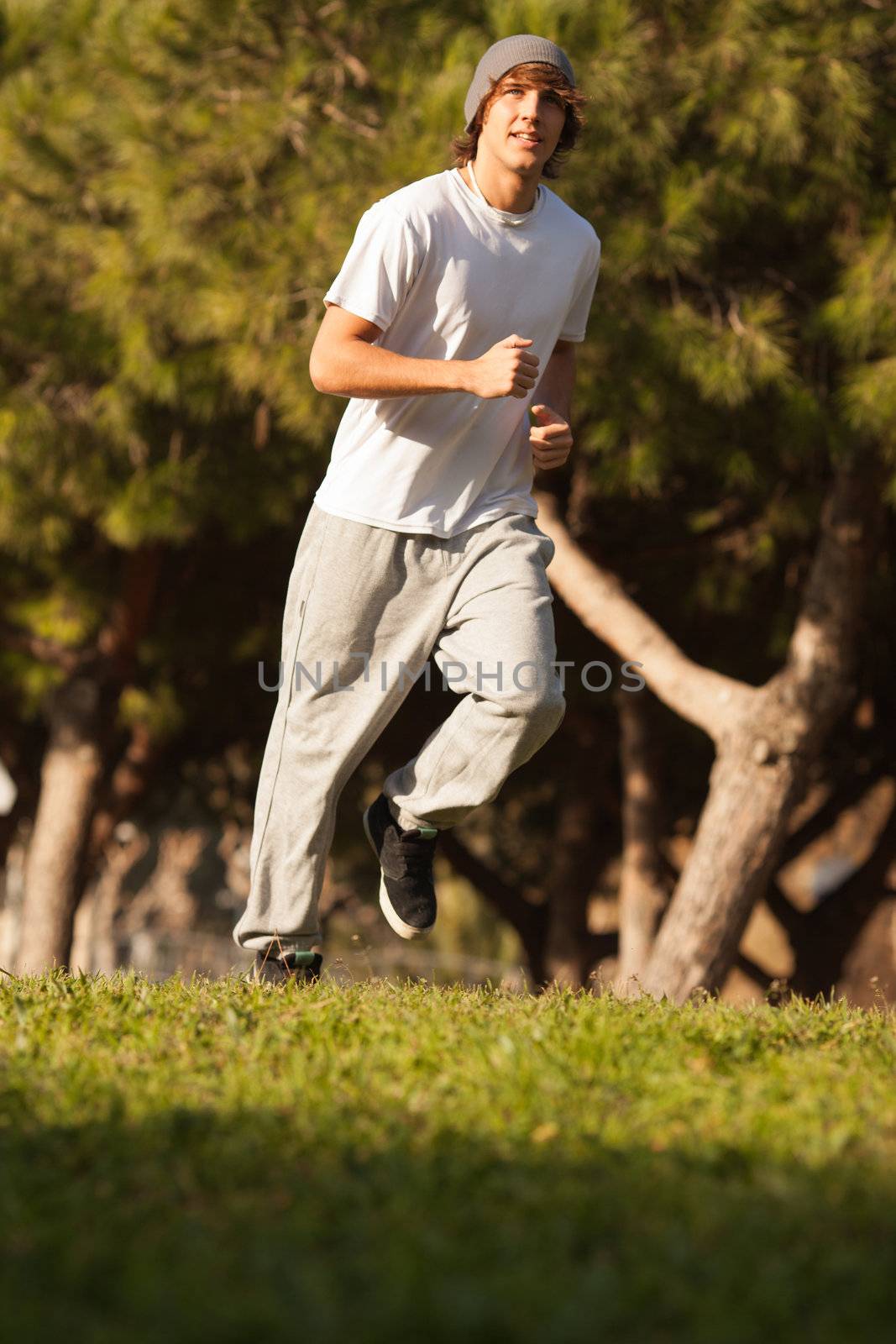 young handsome man jogging in public park