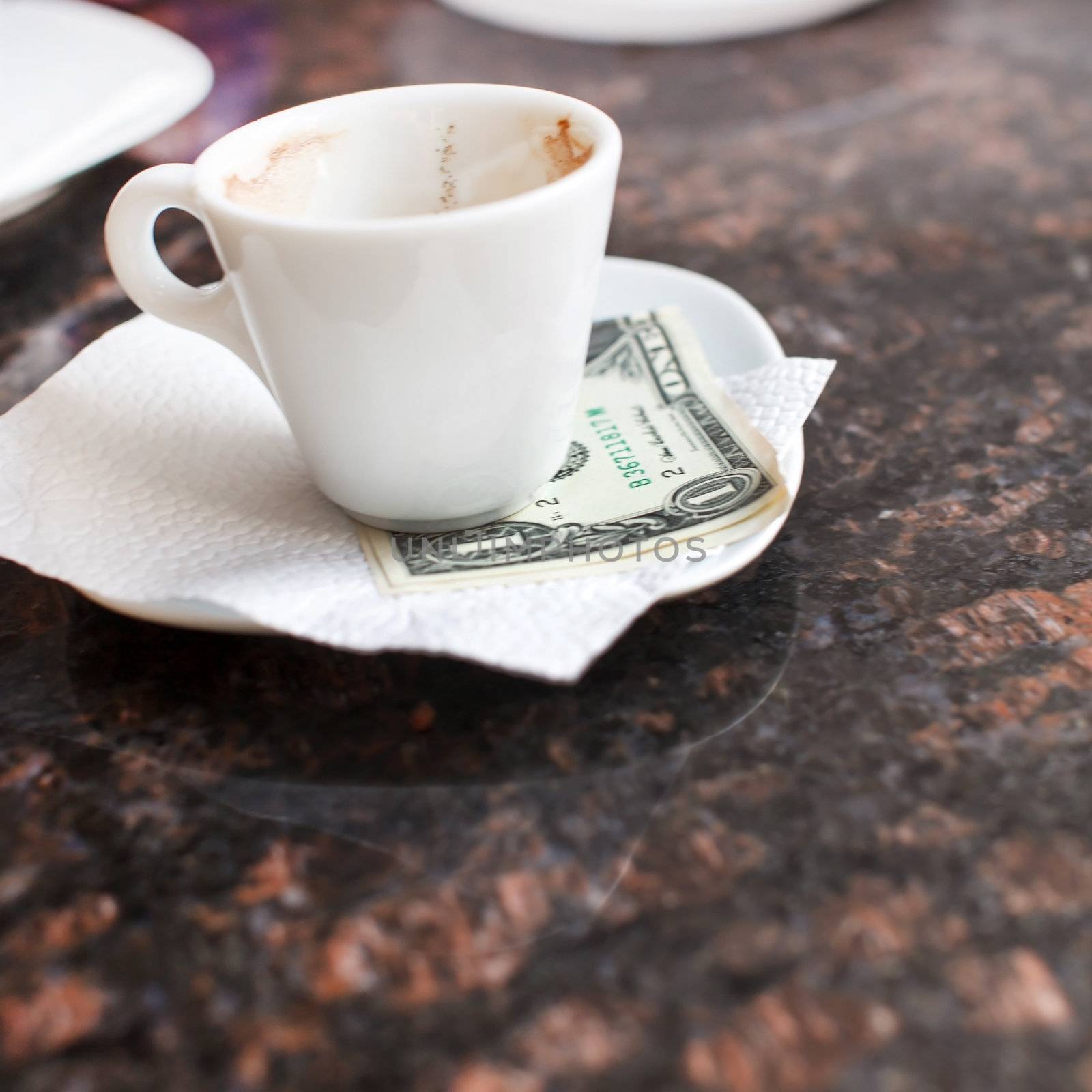 dollar bills under a coffee cup  by shebeko