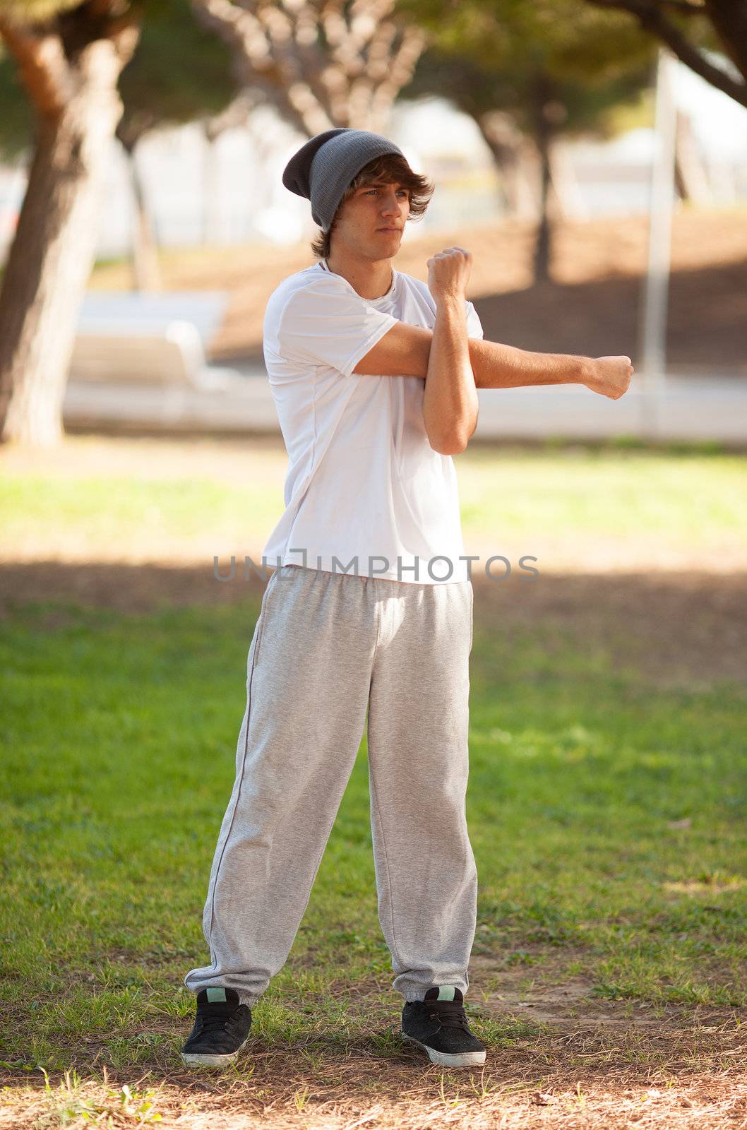 young man portrait stretching after jogging