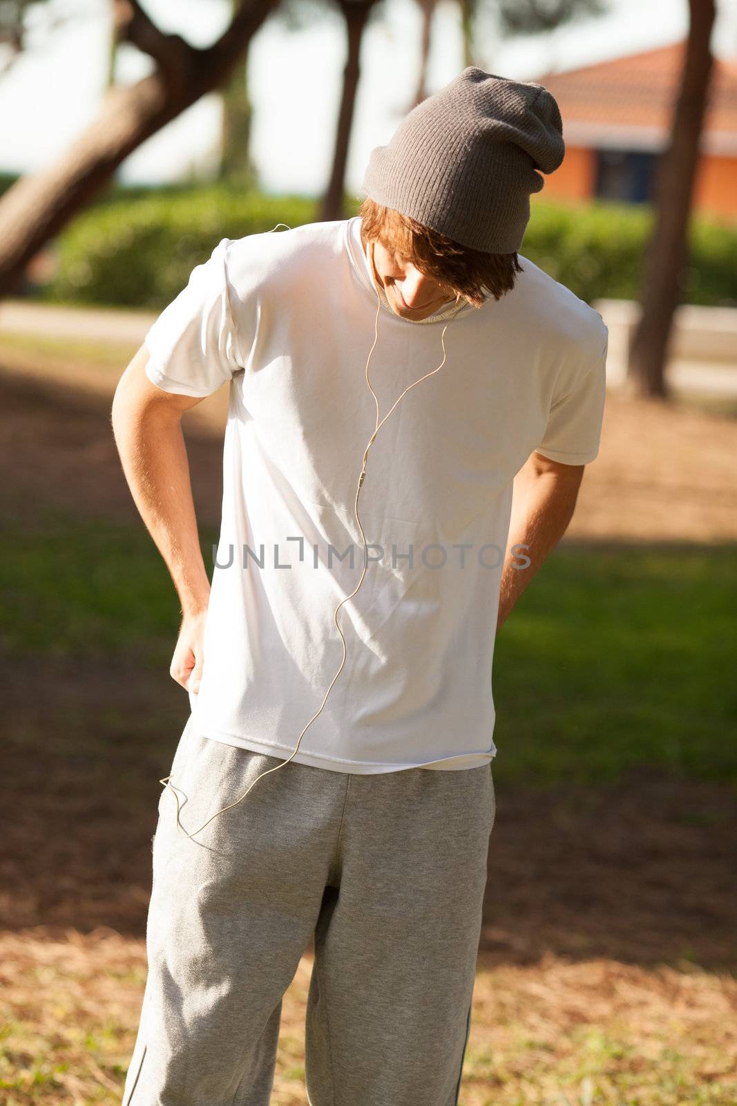 young man portrait stretching after jogging