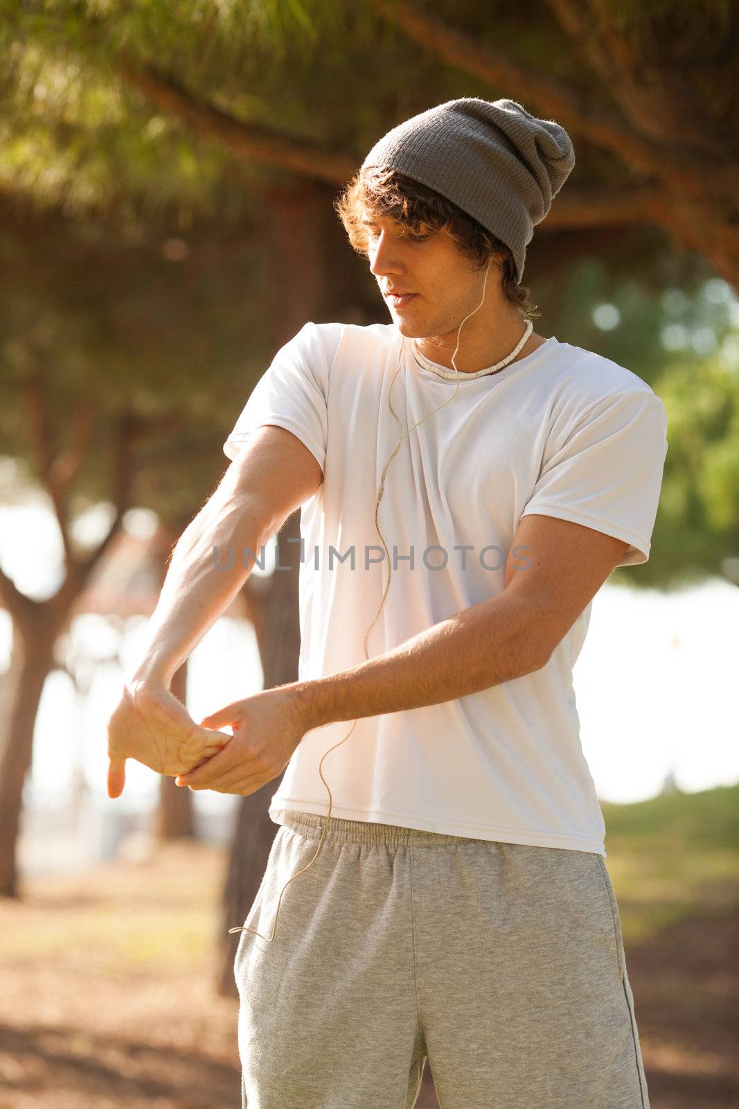 young man portrait stretching after jogging