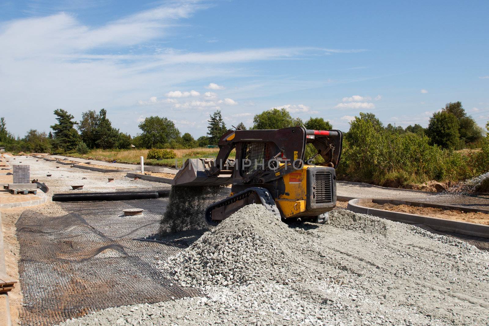 small excavator working at construction of a new street