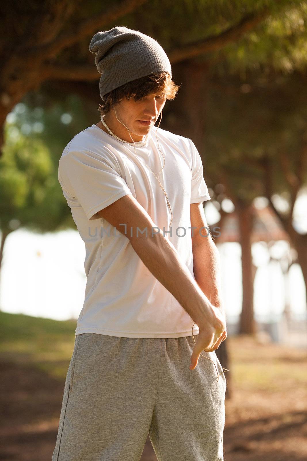 young man portrait stretching after jogging