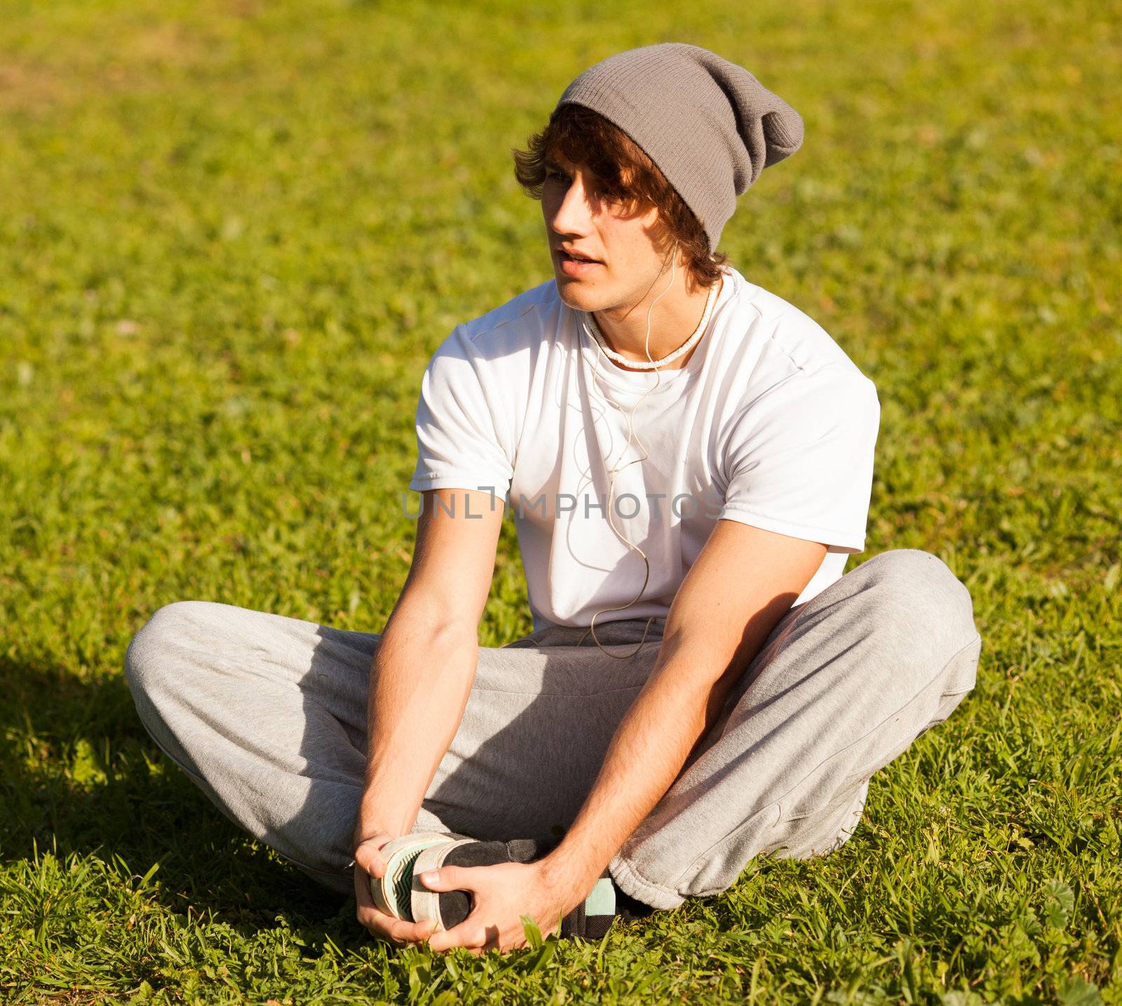 young man portrait stretching after jogging