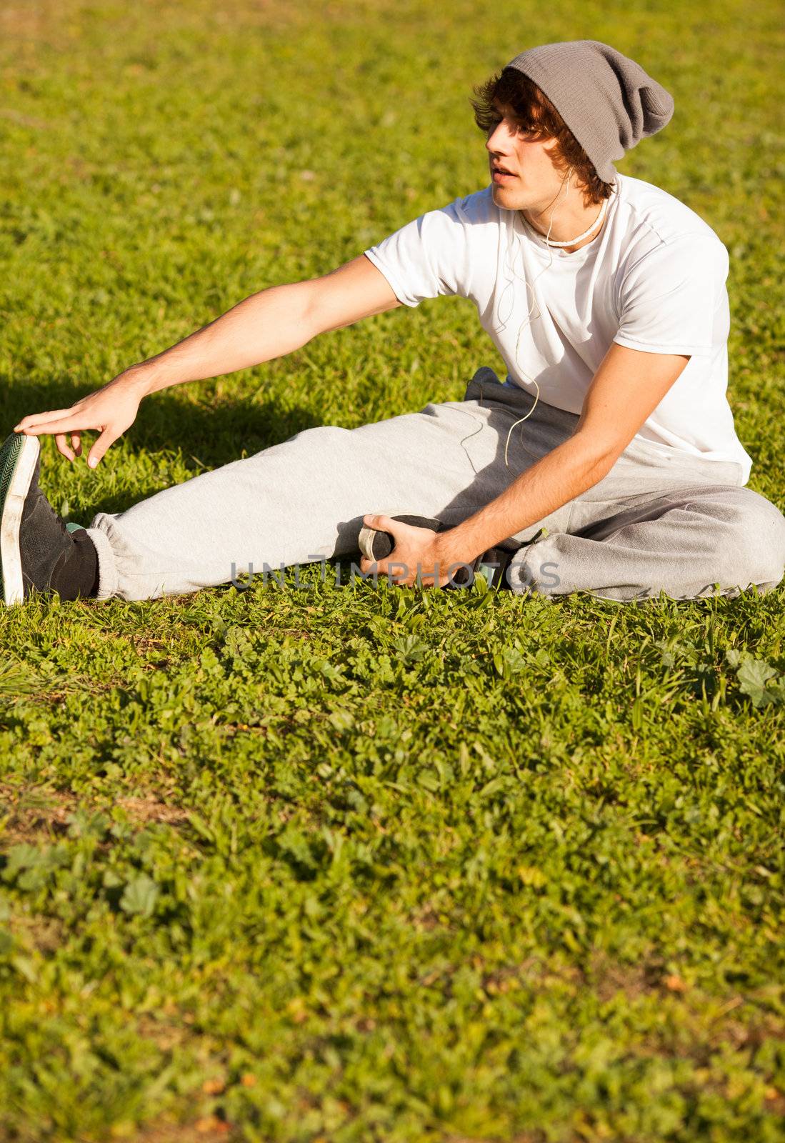 young man portrait stretching after jogging