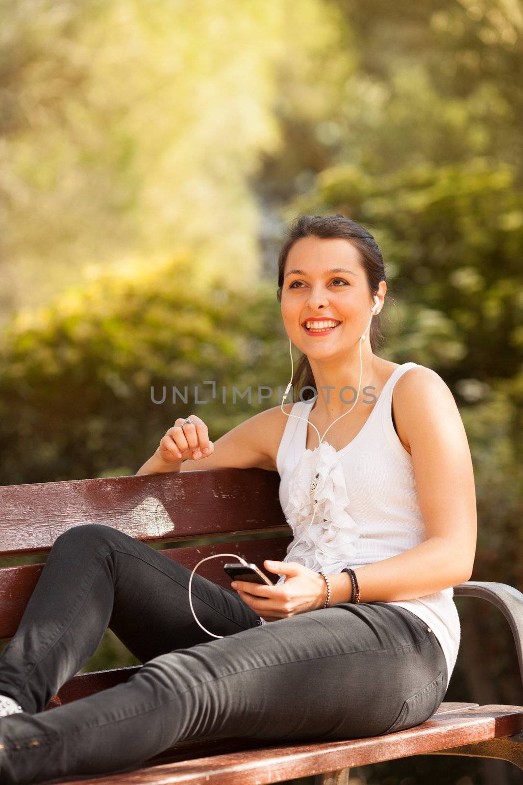 young latin woman using celphone outdoors