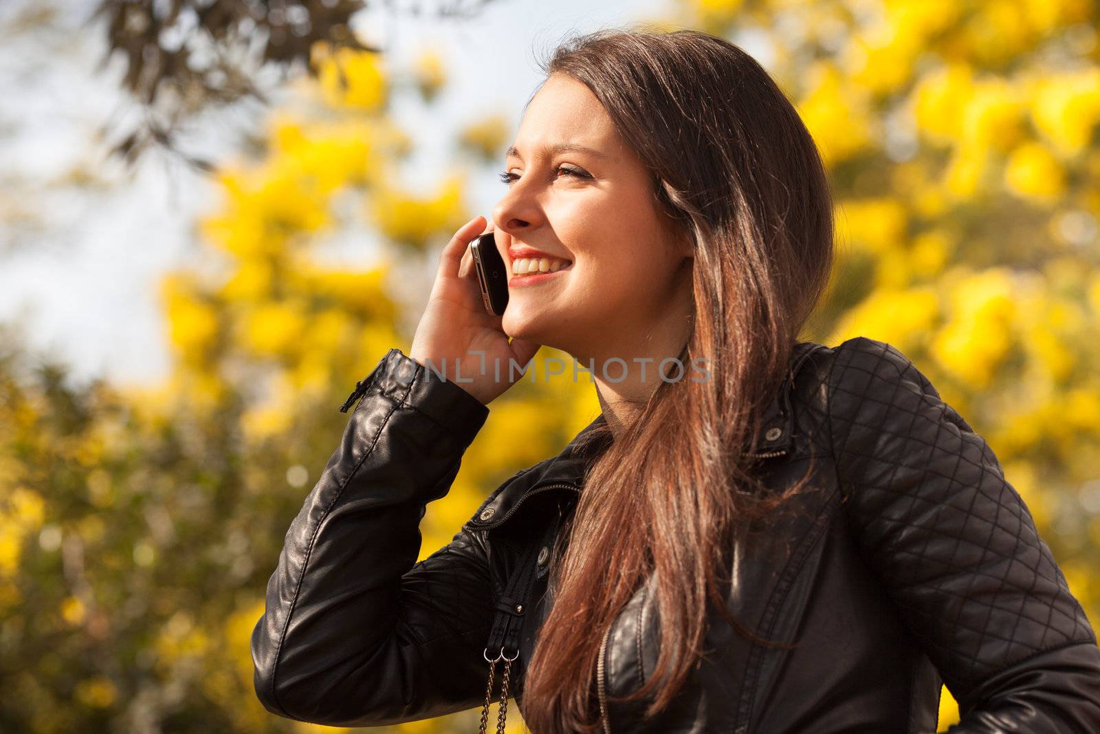 young latin woman using celphone  by Lcrespi