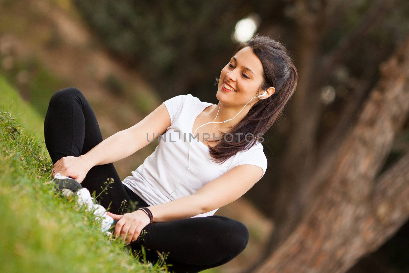 young beautiful woman stretching outdoors