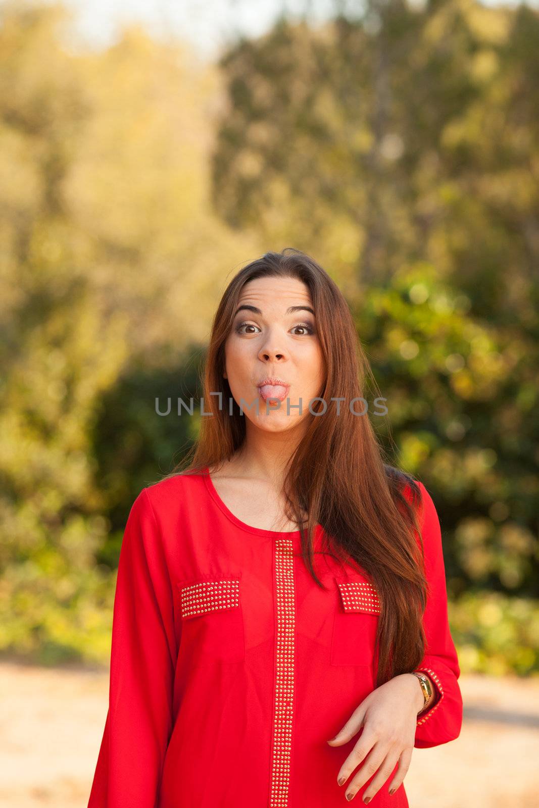 young beautiful woman makes funny face in red shirt