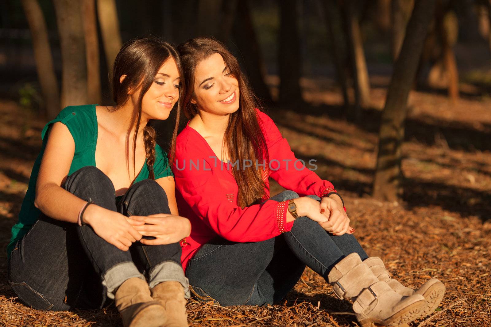 young girlfriends playing on a park by Lcrespi