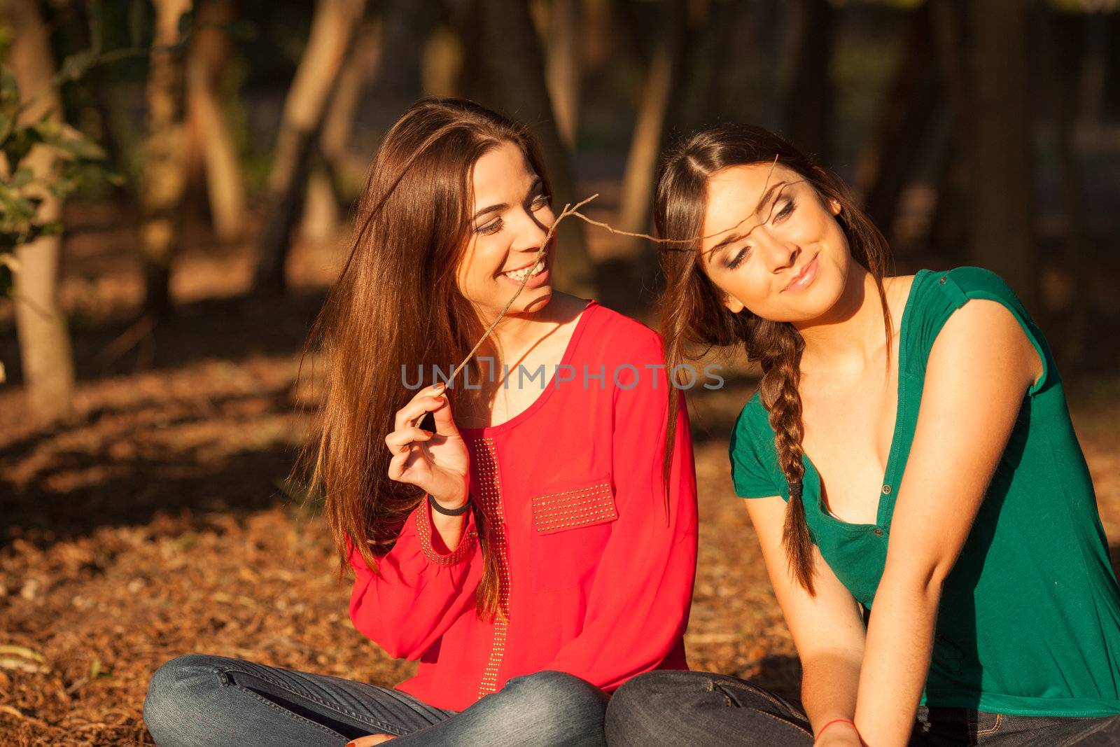 young girlfriends playing on a park by Lcrespi