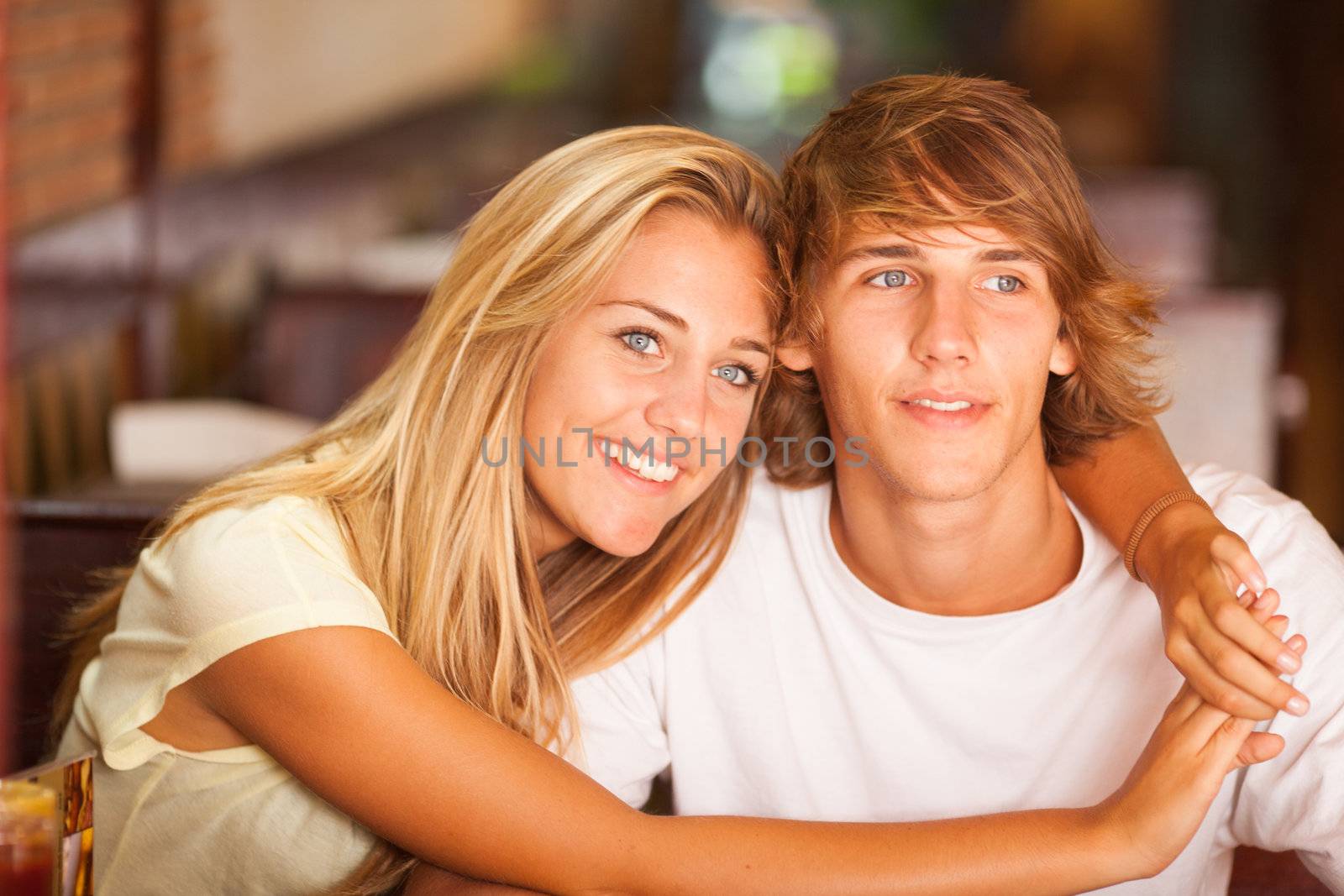 Young beautiful couple having fun in a bar on the beach