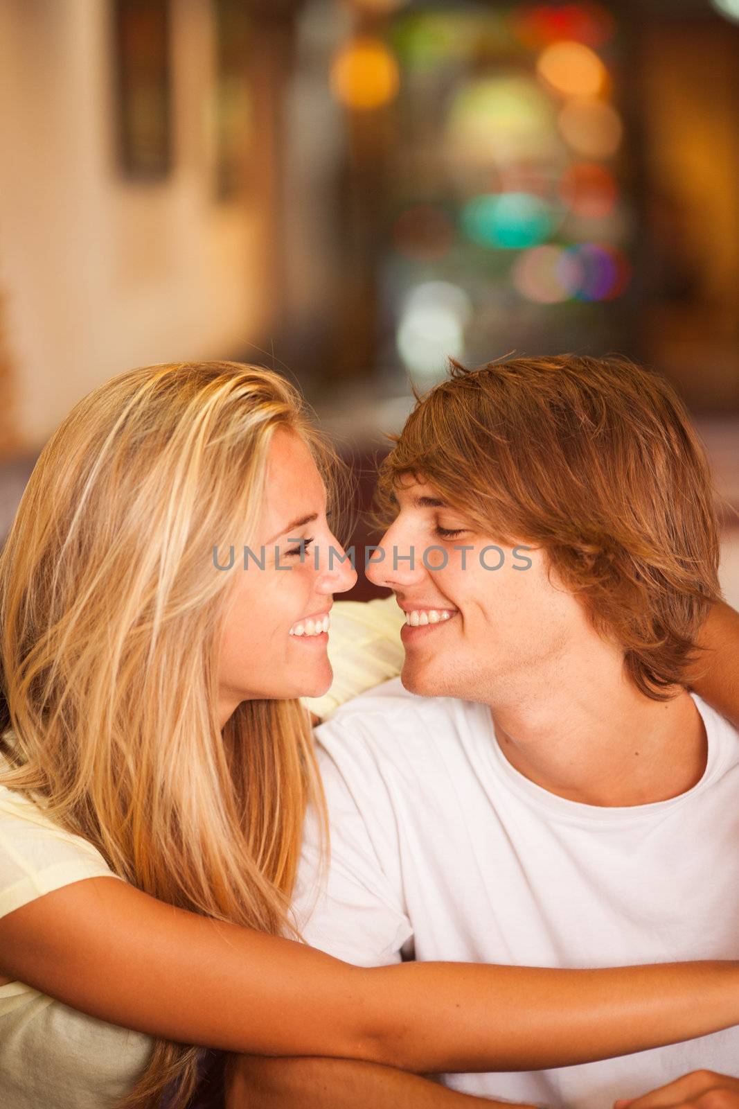 Young beautiful couple having fun in a bar on the beach