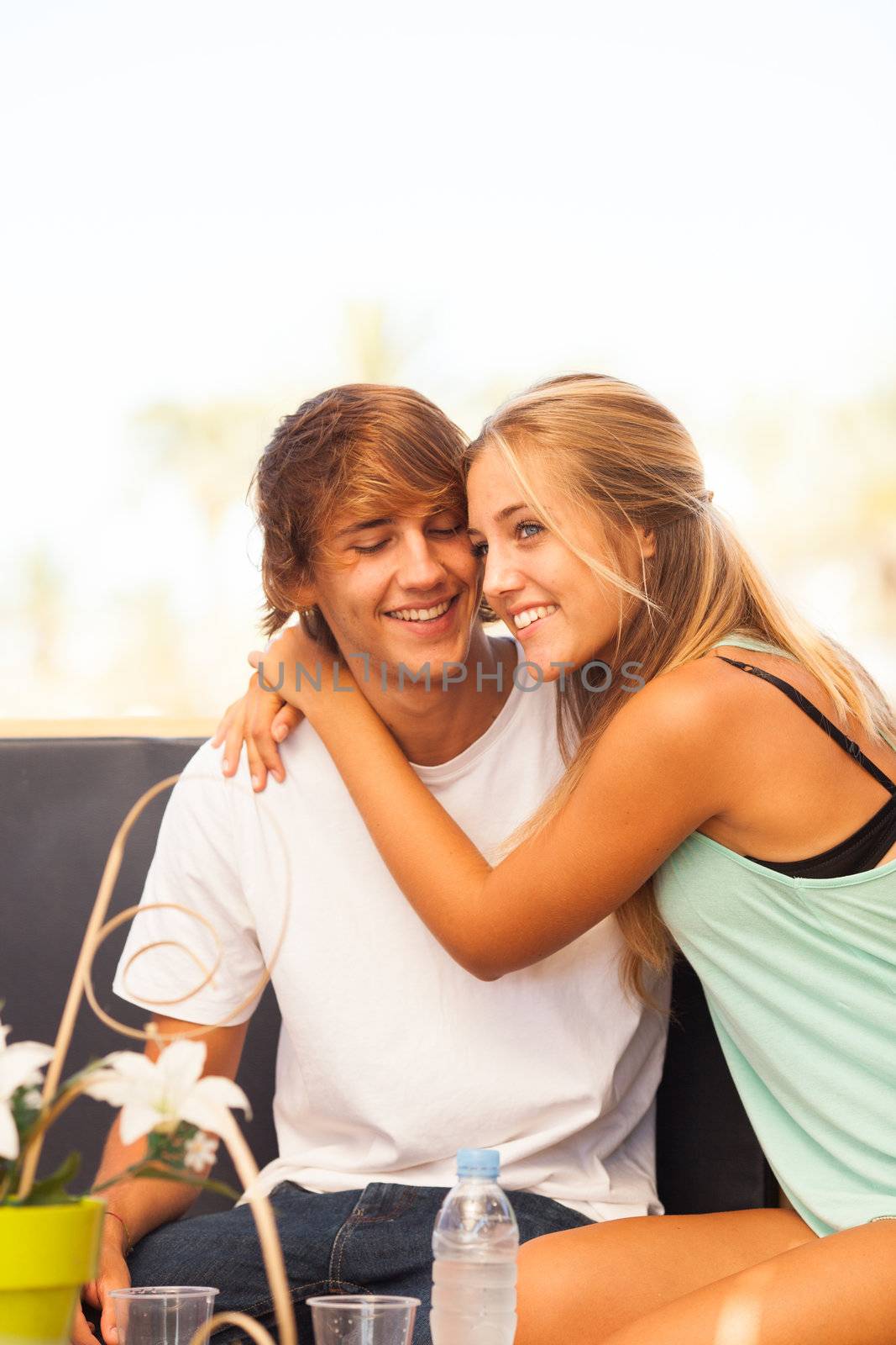 Young beautiful couple having fun in a beach bar