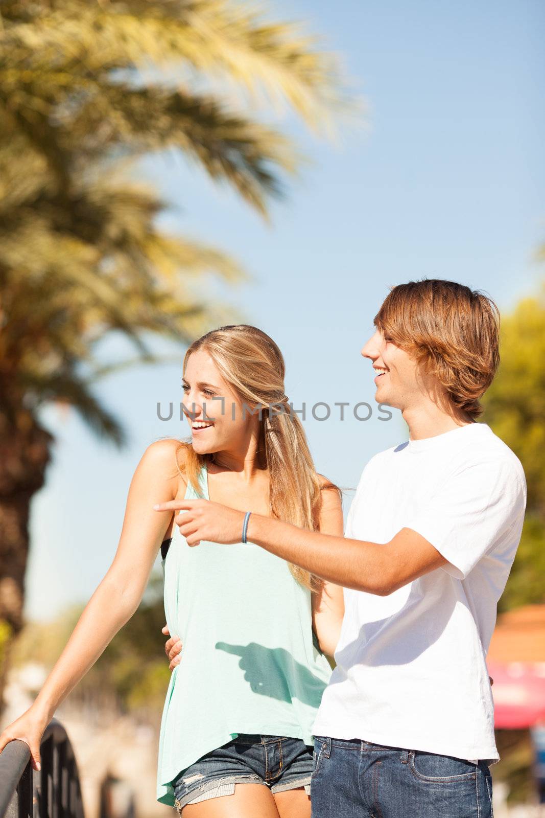 Young romantic beautiful couple enjoying on a walkside with threes