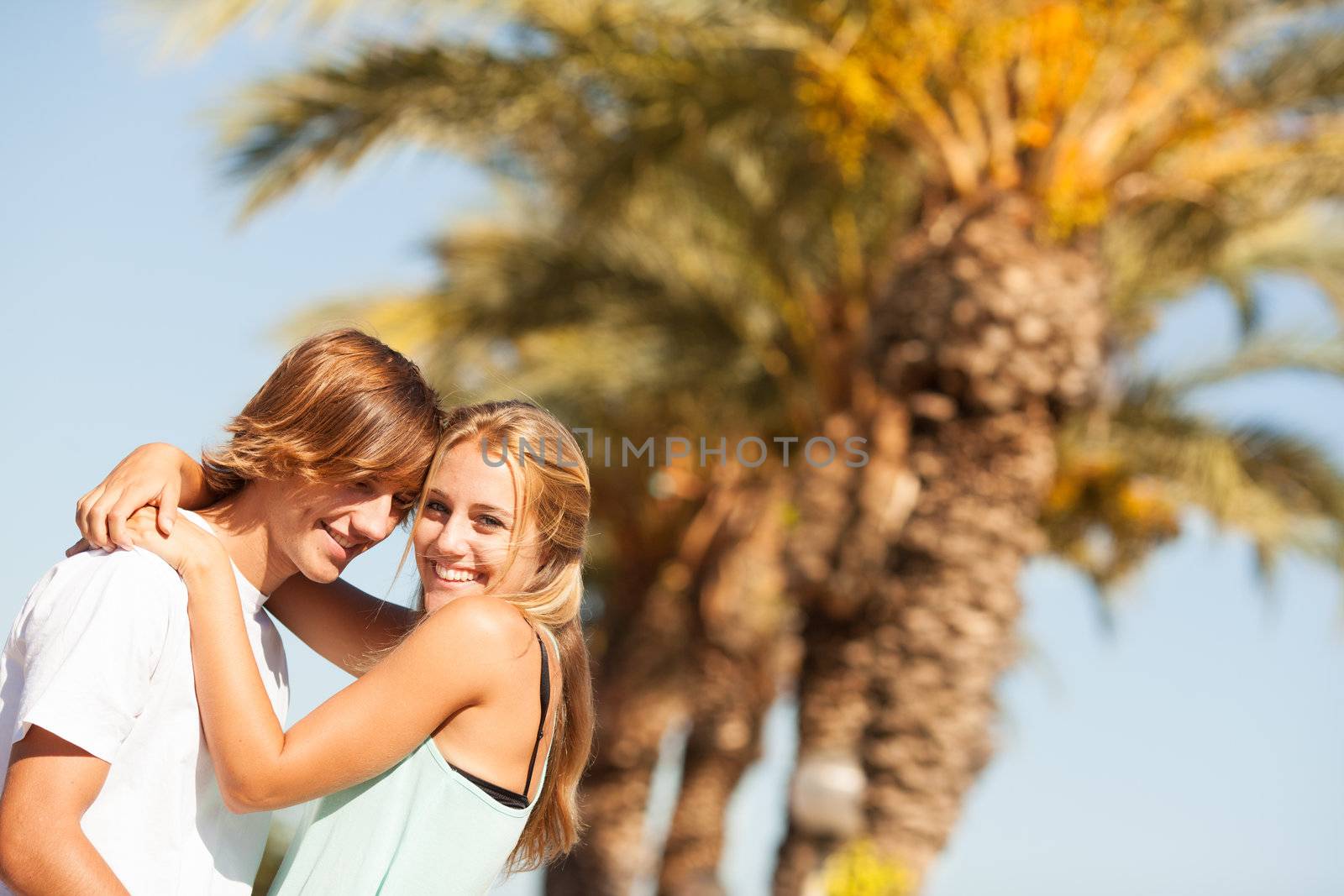 Young romantic beautiful couple enjoying on a walkside with threes