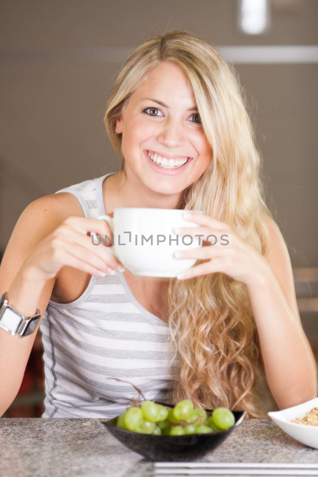 Young beautiful woman enjoying healthy breakfast in the kitchen by Lcrespi