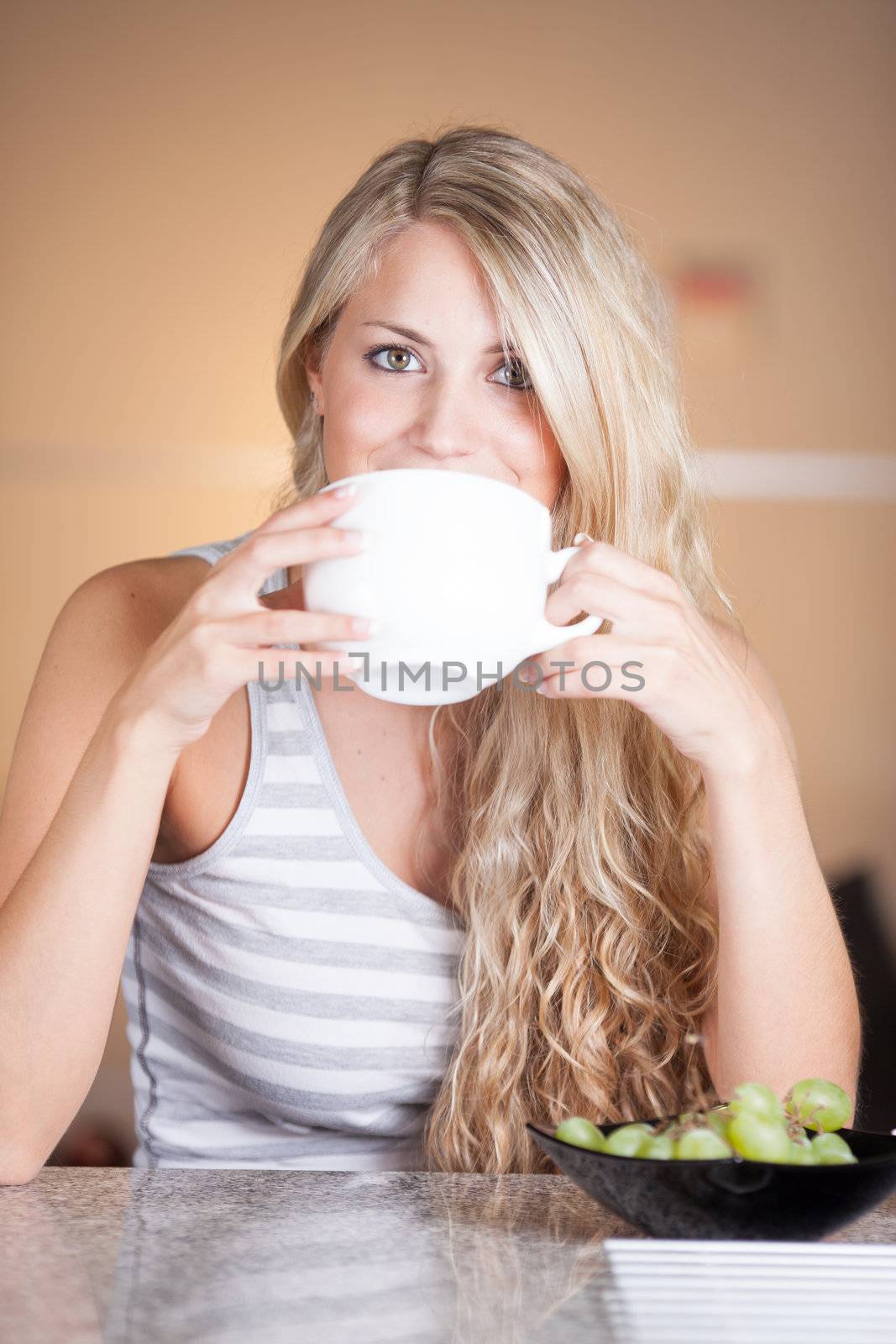 Young beautiful woman having a healthy breakfast in the kitchen