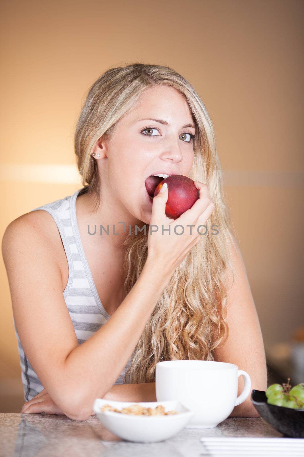 Young beautiful woman enjoying healthy breakfast in the kitchen by Lcrespi