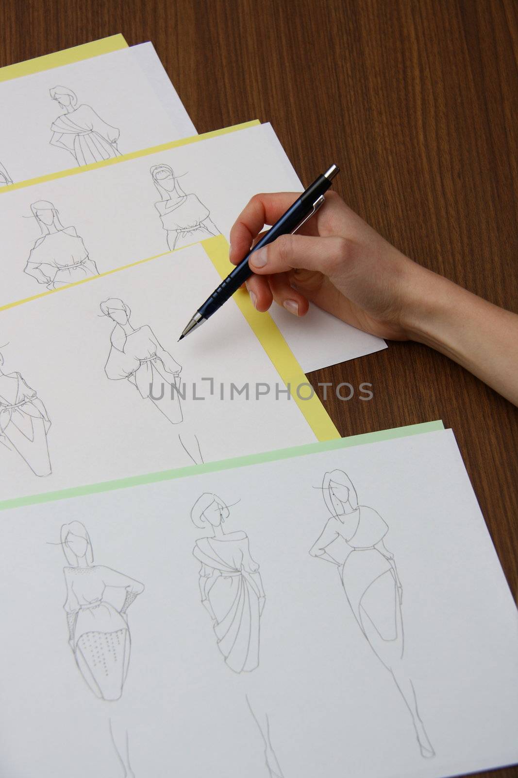 designer assessing fashion drawings by mturhanlar