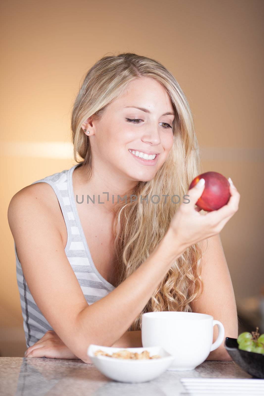 Young beautiful woman enjoying healthy breakfast in the kitchen by Lcrespi