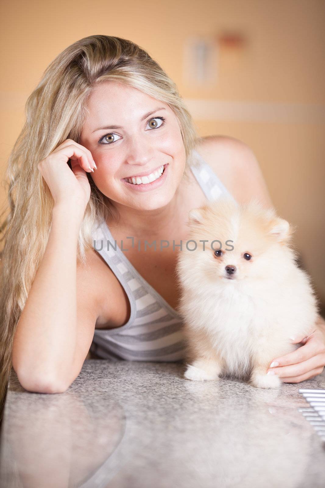 young woman playing with her tinny dog at home