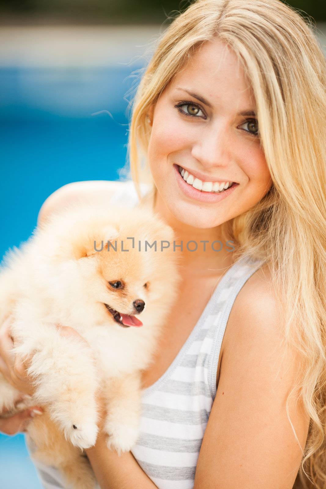 young woman playing with her tinny dog at home