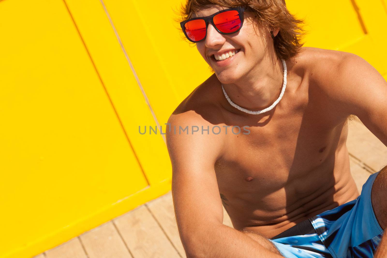 handsome man watching the sea on a lifeguard house